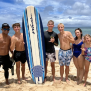 Professional Hawaii surfer Kala Grace teaches group surfing class, North Shore, Oahu. Teens learning to surf.
