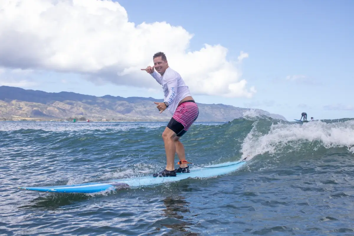 Beginner learning to surf on the North Shore during the winter at Puaena Point. North Shore Oahu Surf School lesson.
