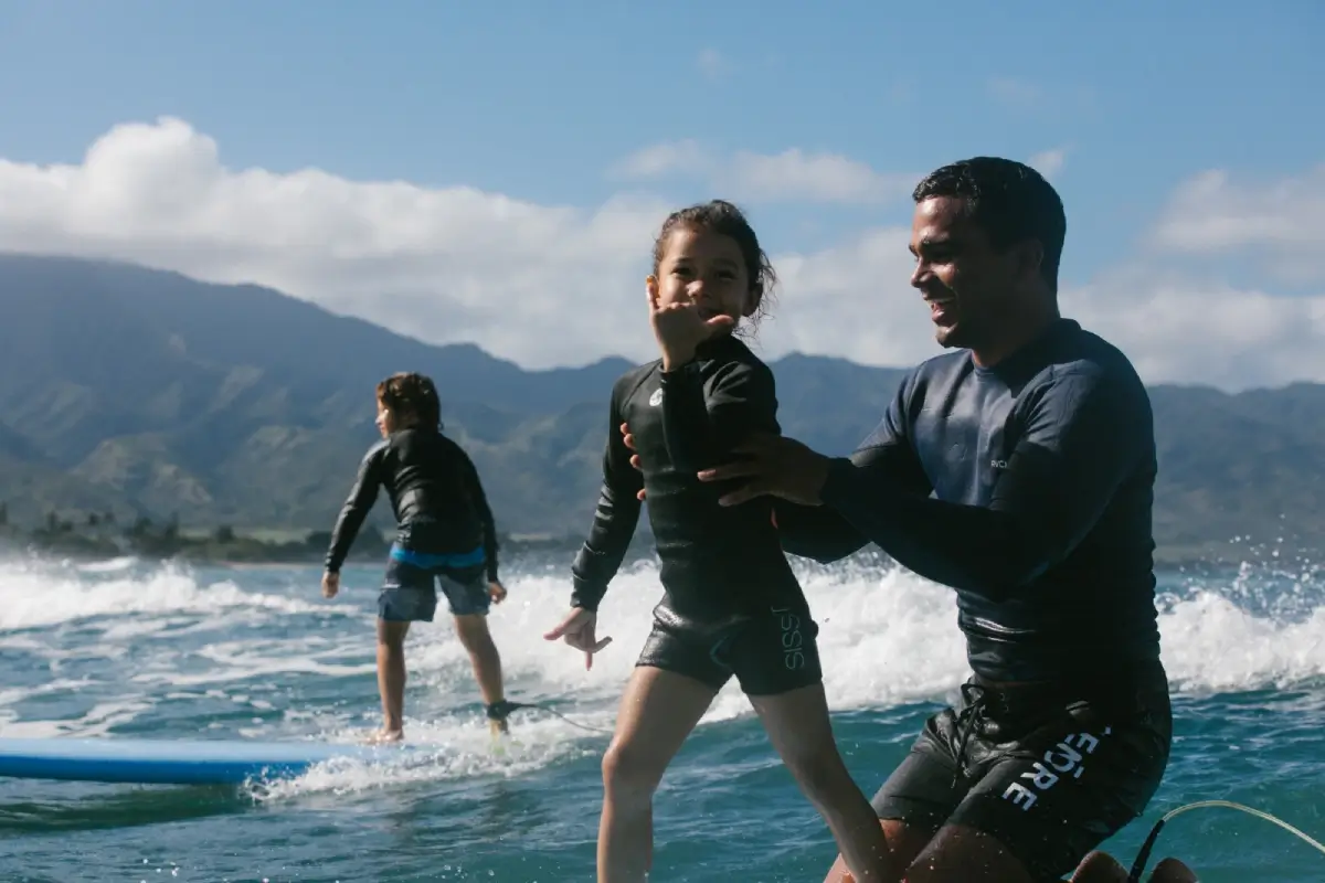North Shore surfing coach, Kala Grace, teaches kids the basics of surfing in Hawaii. Beginner surf classes at North Shore Oahu Surf School.